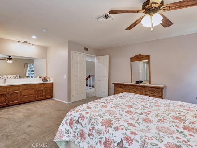 bedroom with a ceiling fan, baseboards, visible vents, and light carpet