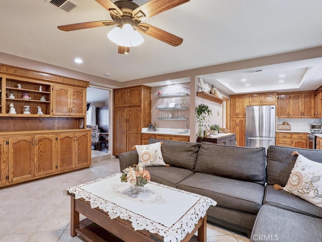 living area featuring visible vents, recessed lighting, light tile patterned floors, a raised ceiling, and ceiling fan