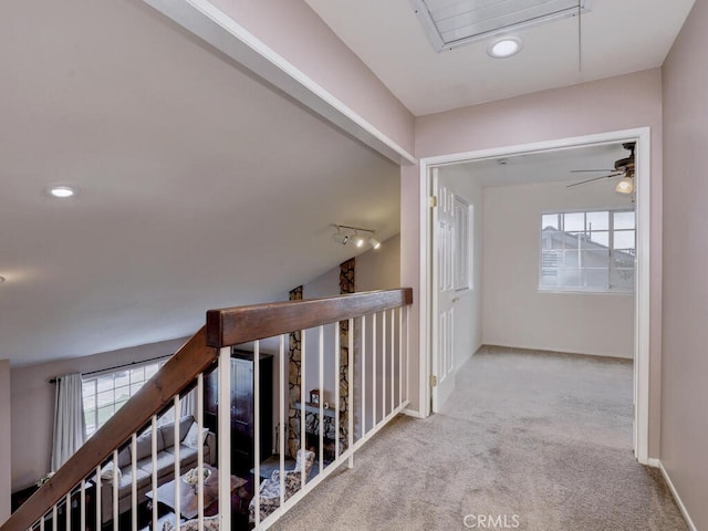 hallway with baseboards, attic access, recessed lighting, track lighting, and carpet flooring