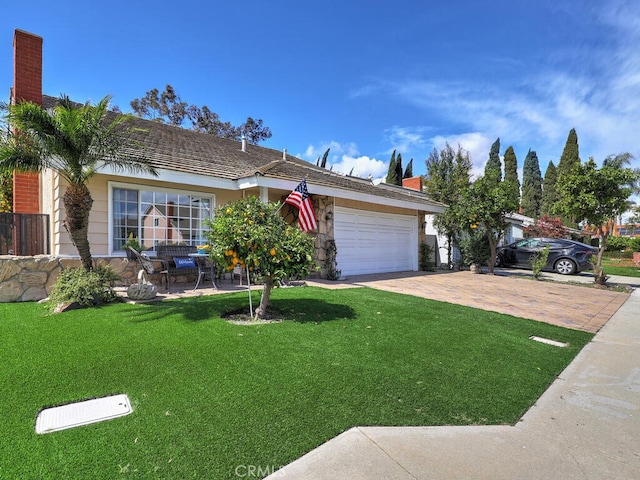 ranch-style house with a front yard, decorative driveway, a garage, and a chimney