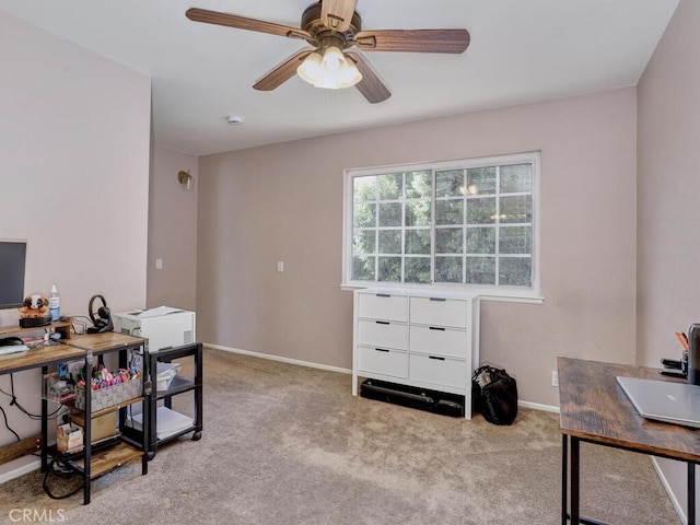 home office with carpet flooring, baseboards, and a ceiling fan