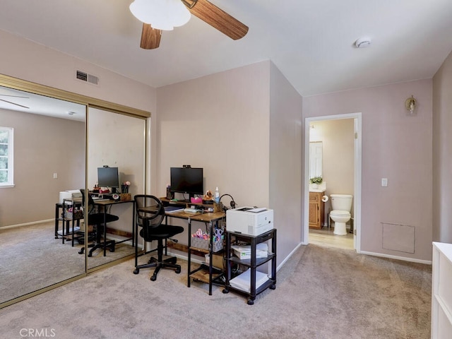 office space with baseboards, visible vents, carpet floors, and ceiling fan