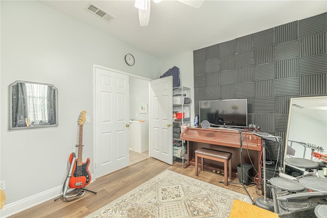 office area featuring visible vents, baseboards, ceiling fan, and wood finished floors