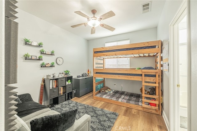 bedroom with visible vents, a ceiling fan, and wood finished floors