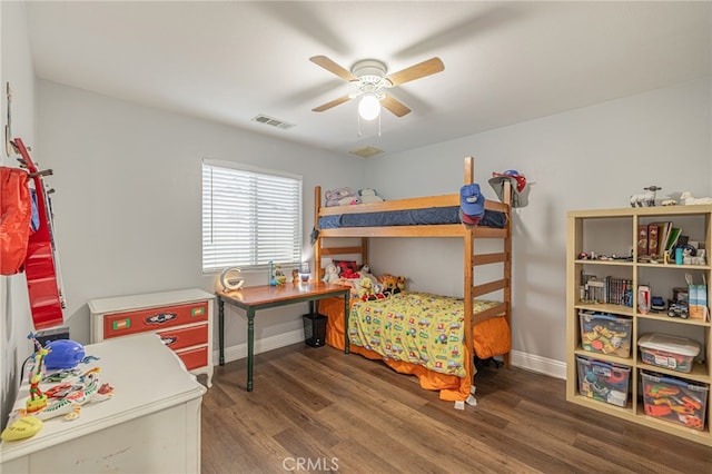 bedroom with ceiling fan, wood finished floors, visible vents, and baseboards