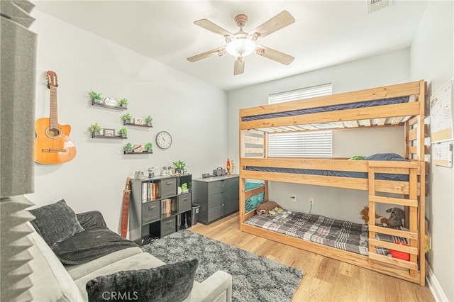 bedroom featuring visible vents, wood finished floors, and a ceiling fan