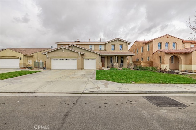 view of front facade featuring a front yard, driveway, solar panels, stucco siding, and a garage