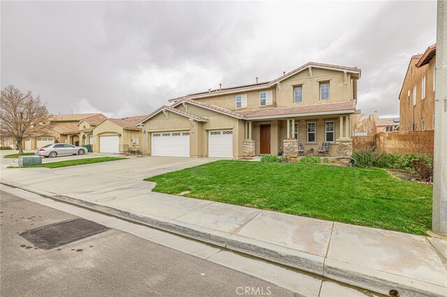 craftsman-style house with fence, a front yard, covered porch, stucco siding, and driveway