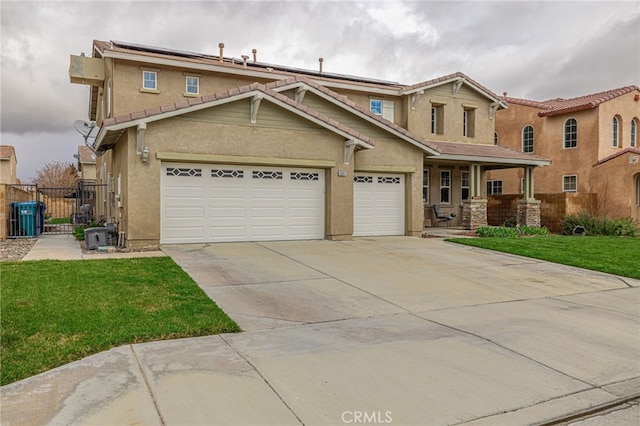 view of front of house featuring stucco siding, driveway, a front yard, and fence