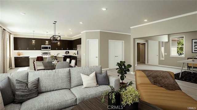 living area featuring recessed lighting, light wood finished floors, and ornamental molding