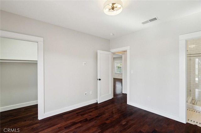 unfurnished bedroom with visible vents, baseboards, and wood finished floors