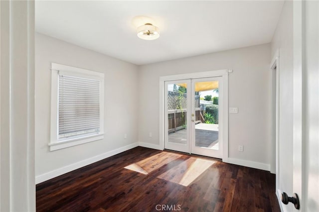 interior space featuring dark wood finished floors, french doors, and baseboards