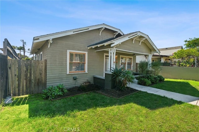 view of front of property with a front yard and fence