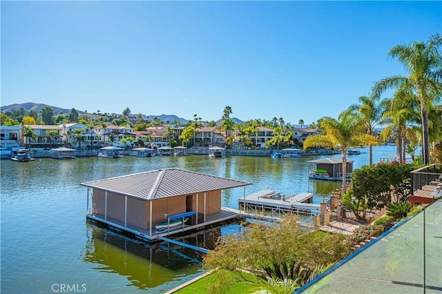 dock area with boat lift and a water and mountain view