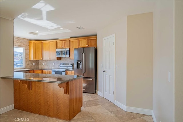 30360 Point Marina Dr, Canyon Lake, CA 92587 - kitchen with a peninsula, baseboards, a kitchen breakfast bar, backsplash, and stainless steel appliances