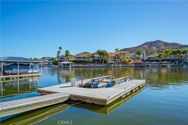 dock area featuring a residential view and a water and mountain view