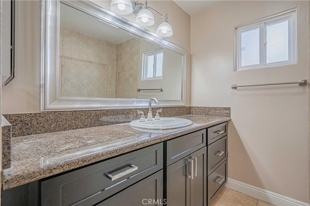 bathroom featuring tile patterned floors, vanity, and baseboards