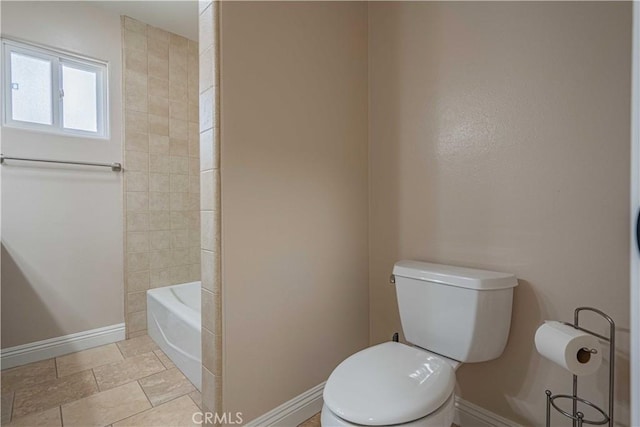 bathroom with a bath, toilet, a shower, and baseboards