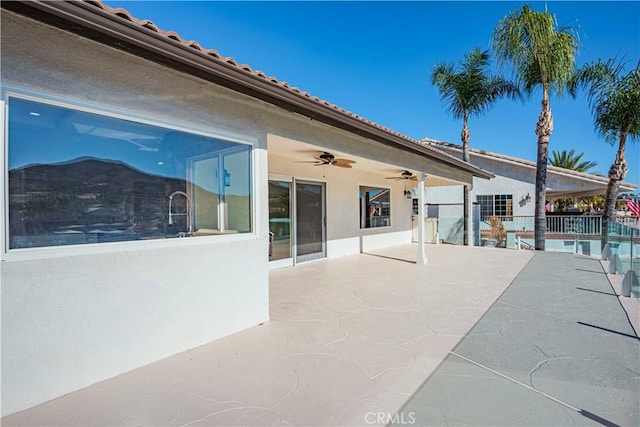 view of patio / terrace with ceiling fan and fence