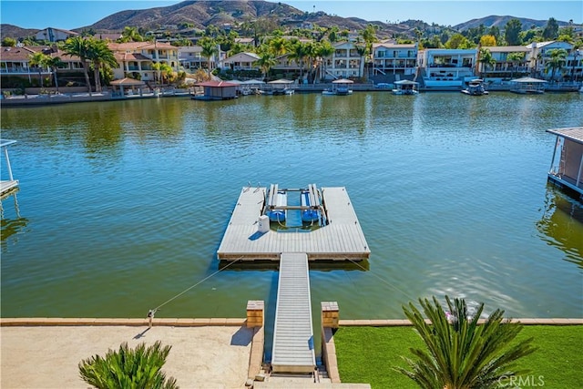 dock area featuring a residential view and a water and mountain view