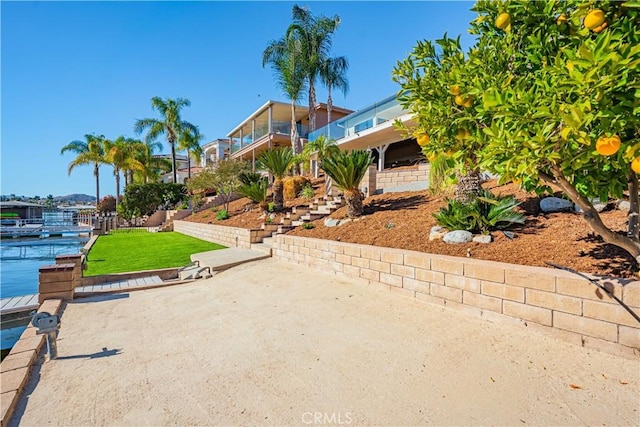 exterior space with stairway and a water view