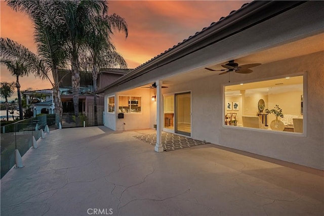 30360 Point Marina Dr, Canyon Lake, CA 92587 - patio terrace at dusk featuring a ceiling fan and fence