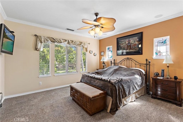 carpeted bedroom featuring ceiling fan, baseboards, visible vents, and ornamental molding