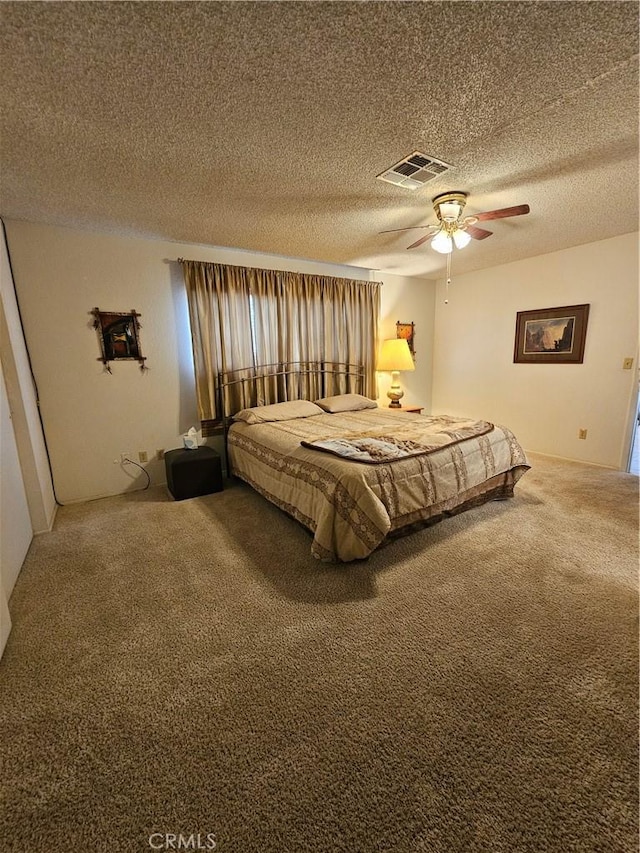 bedroom featuring a textured ceiling, carpet, visible vents, and ceiling fan