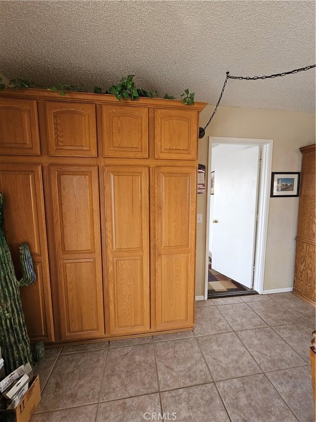 interior details featuring baseboards and a textured ceiling