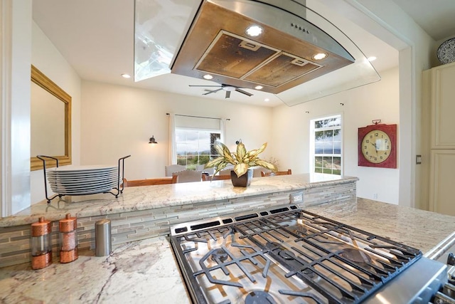 kitchen with recessed lighting, light stone countertops, a ceiling fan, and gas stove