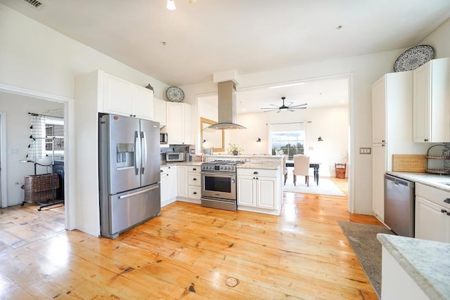 kitchen with white cabinetry, island exhaust hood, stainless steel appliances, and light wood-style floors