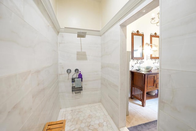 bathroom featuring tile patterned floors, vanity, and a tile shower