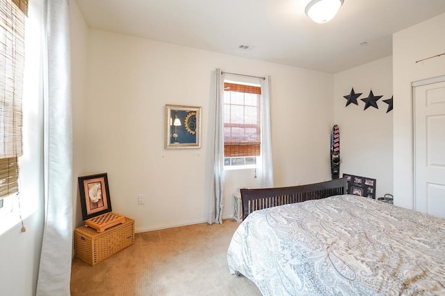 carpeted bedroom featuring baseboards