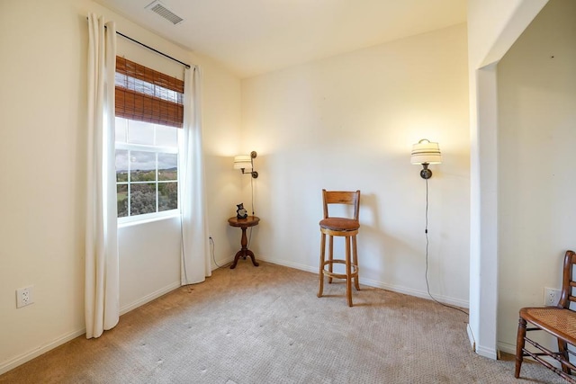 spare room with carpet, visible vents, and baseboards