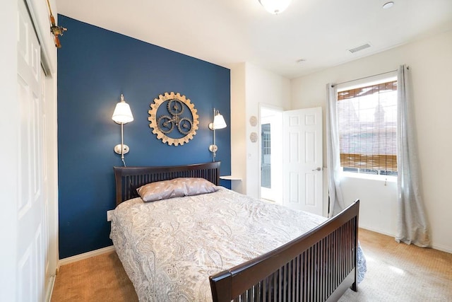 carpeted bedroom with visible vents and baseboards