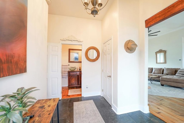 interior space with baseboards and a chandelier