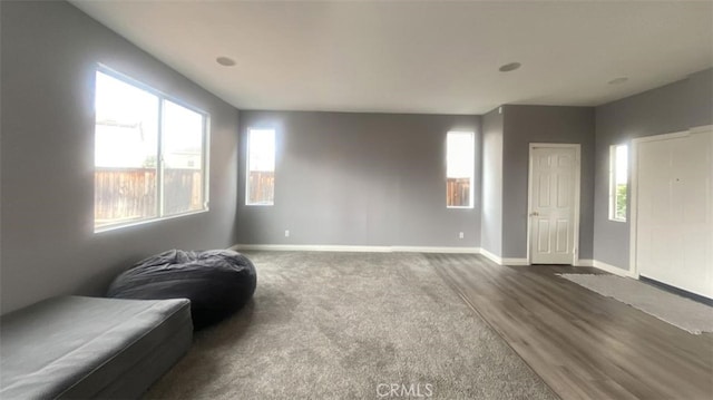 interior space featuring baseboards and dark wood-type flooring