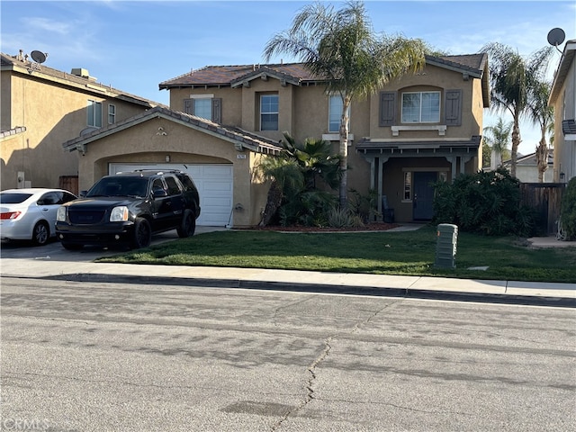 view of front of house with a front yard, concrete driveway, a garage, and stucco siding