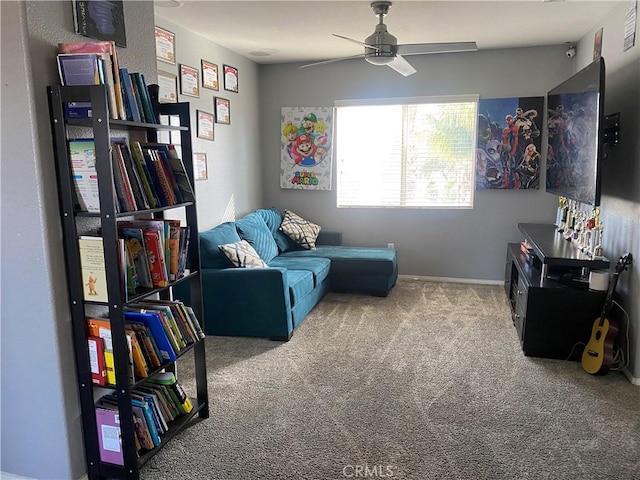 living area featuring carpet and ceiling fan