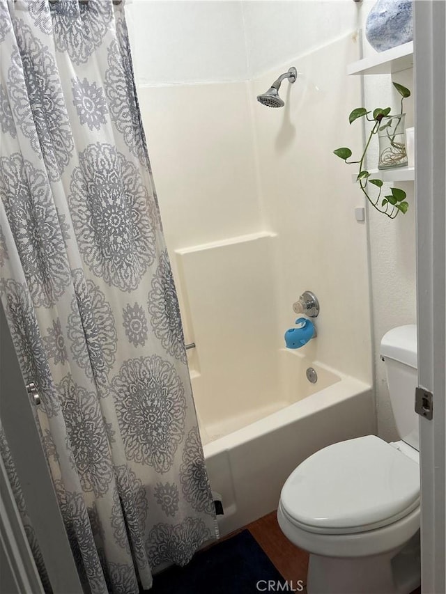 bathroom with shower / tub combo and toilet