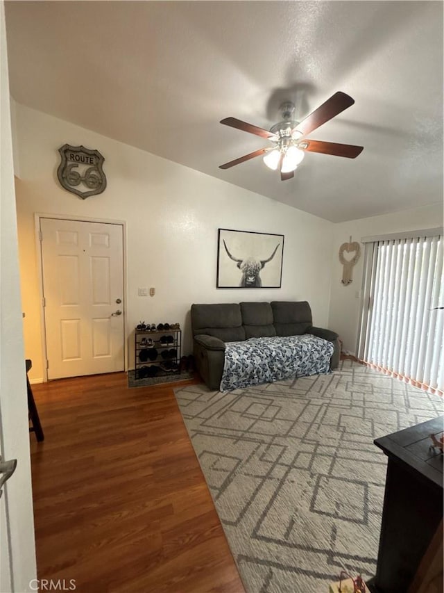 living room with lofted ceiling, a ceiling fan, and wood finished floors