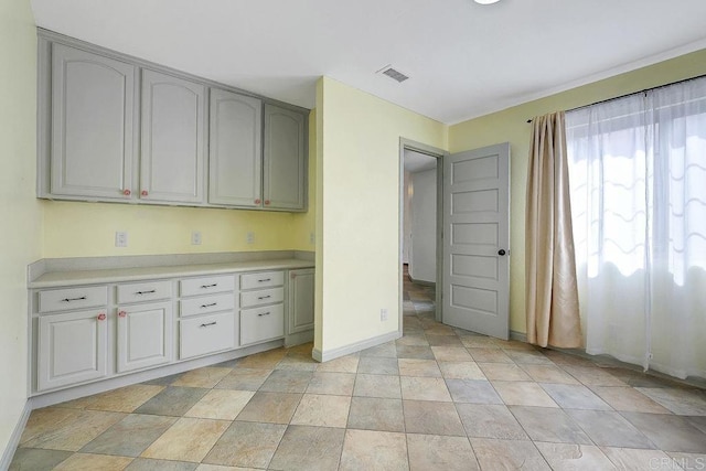 kitchen featuring visible vents, baseboards, and light countertops