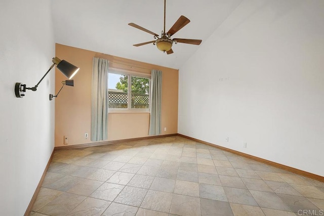 spare room with baseboards, high vaulted ceiling, and ceiling fan