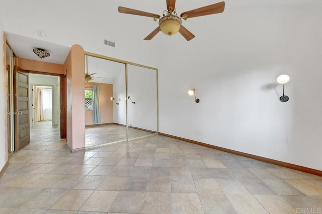 unfurnished bedroom with a closet, visible vents, ceiling fan, and baseboards