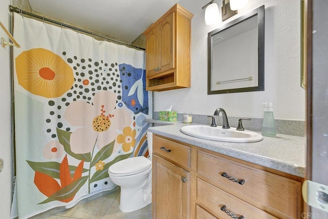 bathroom featuring tile patterned floors, a shower with shower curtain, toilet, and vanity