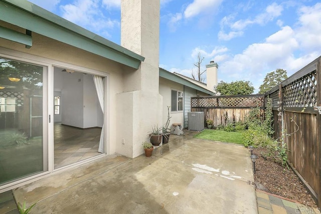 view of patio with central air condition unit and a fenced backyard