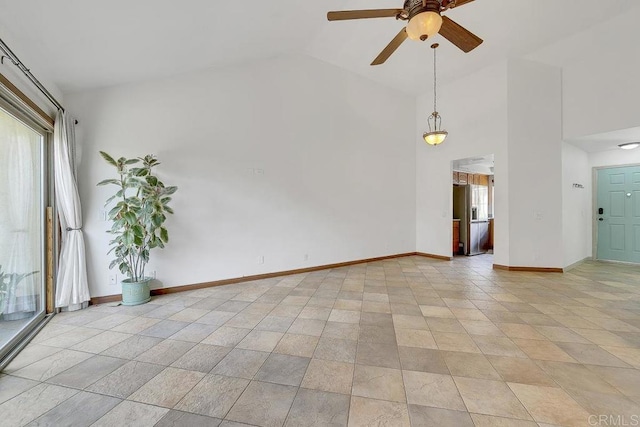 unfurnished room featuring high vaulted ceiling, baseboards, and ceiling fan