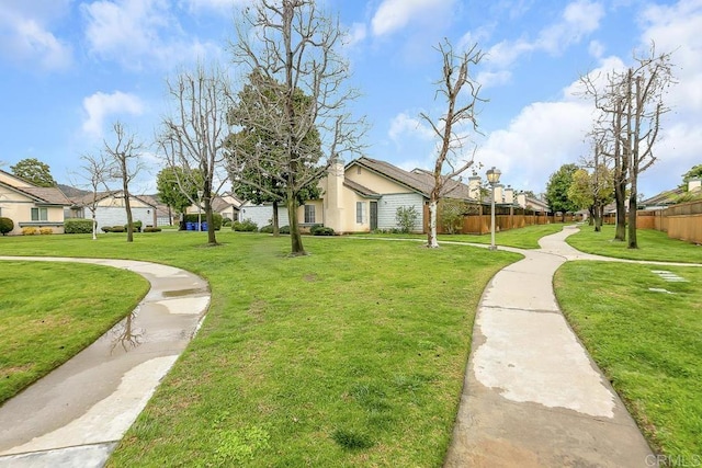 surrounding community featuring a yard and fence