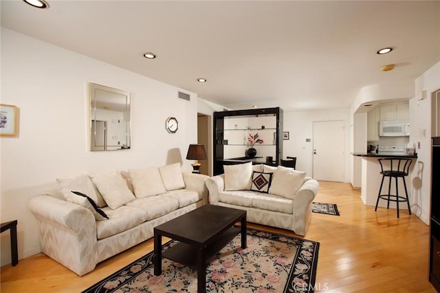 living area featuring recessed lighting, visible vents, and light wood-type flooring