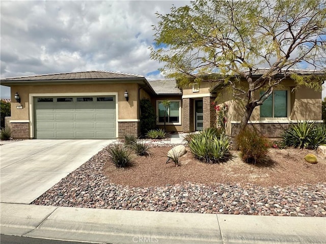 view of front of home with brick siding, a tile roof, stucco siding, driveway, and an attached garage